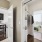 hall with open doors looking into kitchen and bedroom