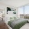 bedroom with oversized picture window with downtown views