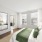 large windows brighten spacious bedroom